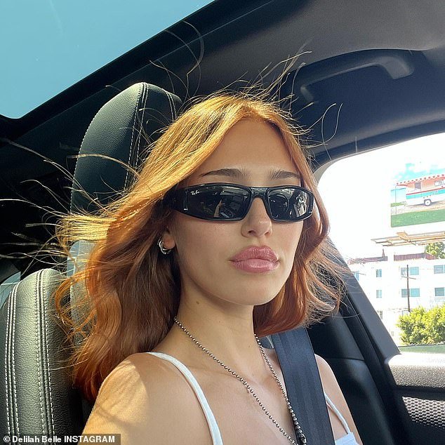 Windy hair: She also shared a snap of herself wearing rectangular sunglasses and her reddish-blonde hair blowing in the breeze as she rides in a car with the windows open.