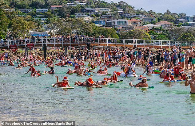 Locals said an increase in summer tourists over the years has caused people to set up campsites in illegal places, litter and put too much strain on the small town's resources (pictured, Crescent's annual Santa Surf Head)