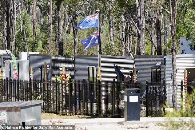 The flags of New Zealand and Australia fly from a pole above Army Donga Row which a property manager told DMA was 