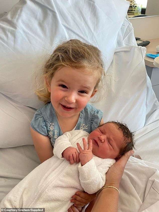Two and a half year old Poppy from Graham shows off her newborn baby sister, Macy.