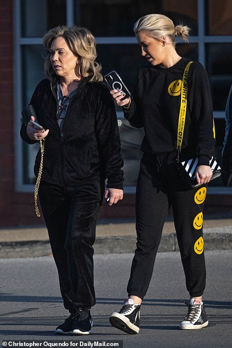 Julie was dressed casually in an all-black velor tracksuit with Nike sneakers as she left a furniture store with her daughter Savannah.