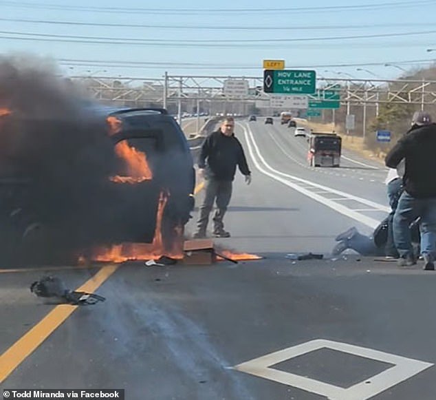A group of good Samaritans jumped into action to help the woman while her car was on fire.