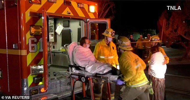 Screenshot from video showing emergency services helping a person into an ambulance following a shooting in Monterey Park, California, USA.