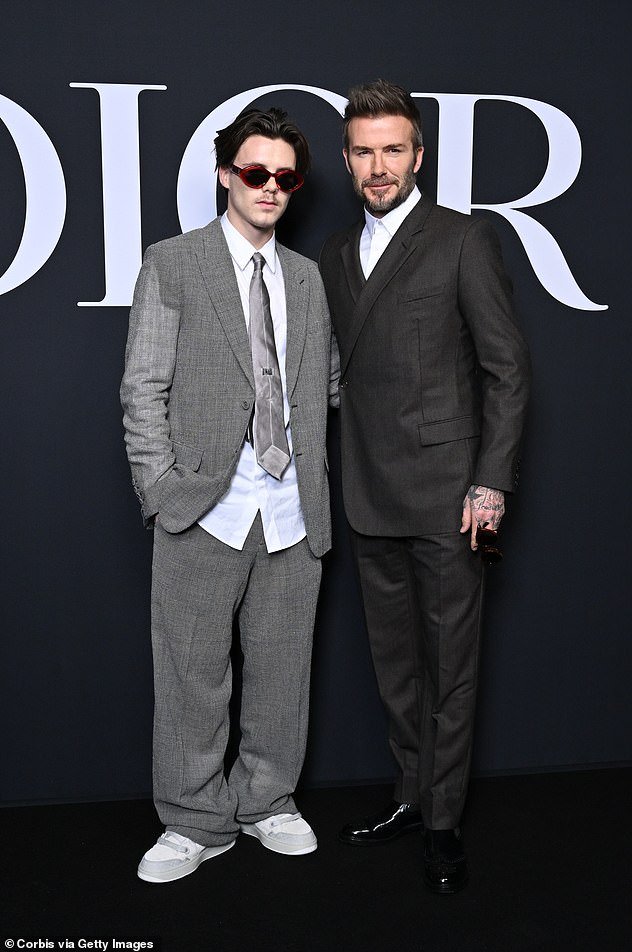 Out and about: David and his son Cruz were among those in attendance at the Dior Homme menswear show on Friday.