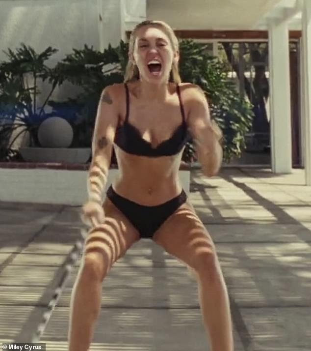 Intense: Skip to the second chorus with footage of Miley, still clad in her skimpy black two-piece, showing off her intense workout regimen.