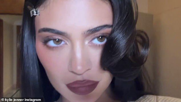 Siren: The 25-year-old reality star rocked smoky purple eyeshadow, a deep blush, and berry lipstick as she pouted during the clip.