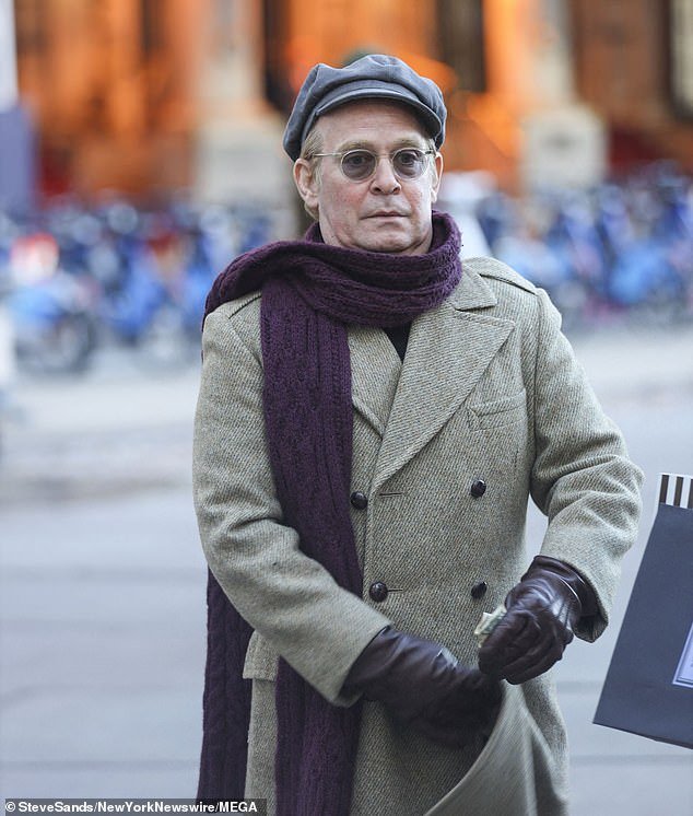 Capote: Tom Hollander, 55, plays Capote.  The British actor wore a double-breasted gray tweed coat, a pageboy's cap and a long purple woolen scarf.