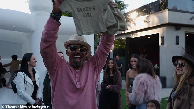 Overjoyed: His loved ones cheered and he beamed with joy while holding a 'Girl dad' T-shirt