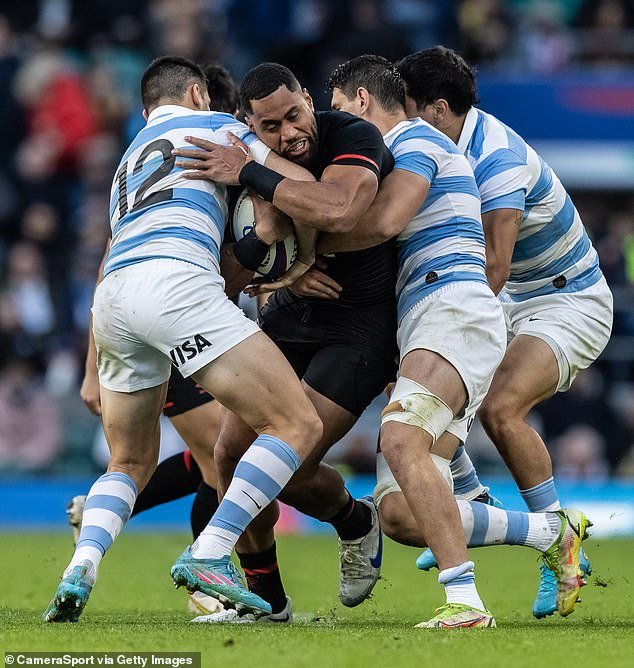 England's Joe Cakanasiga (centre) is tackled by several Argentinian players in the chest area