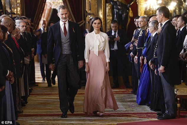 Stunning photos show the royal couple entering a reception room where diplomats were waiting in line.