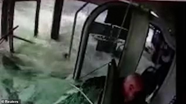 Water cascaded into the bus as footage captured the driver and passengers as they were knocked back by the brutal force of the water