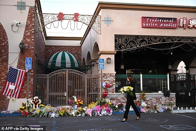Vice President Kamala Harris looks at the makeshift memorial for shooting victims that was built outside the Star Ballroom Dance Studio in Monterey Park, California, after a gunman killed 11 people on Saturday.