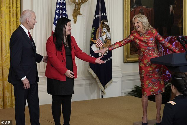 First Lady Jill Biden (right) approaches Elaine Tso (center), CEO of Asian Services in Action, who introduced President Joe Biden (left) at the Lunar New Year event