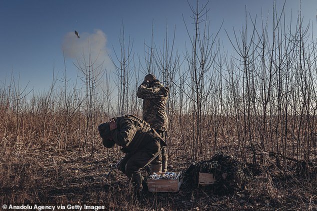 Ukrainian soldiers are seen yesterday in their mortar position on the Donbass front line.