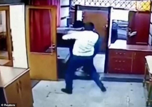Then a hero bursts from a side door and fights the gunman, trying to wrestle the rifle off him