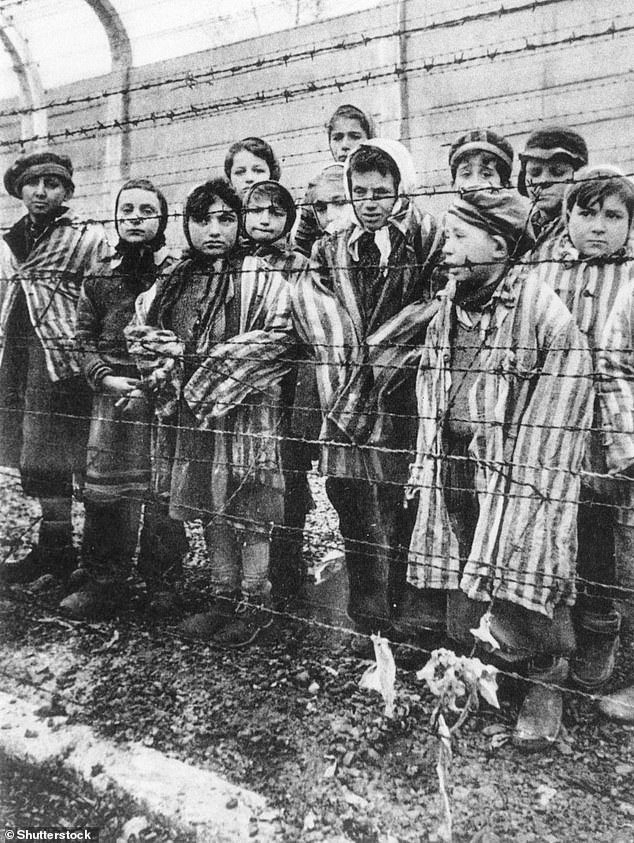 Uri, whose first word was 'coffee', learned later that nine of his close family members, including his aunt and uncle and his nine-year-old cousin Miriam, were killed in Auschwitz concentration camp. Pictured: Children are imprisoned in Auschwitz
