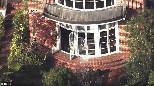 Aerial images showed smashed panels and shattered glass at the back door of Pelosi's home.