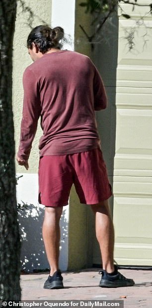 Exclusive images obtained by DailyMail.com show Fernandez dressed casually in maroon shorts and a tank top.