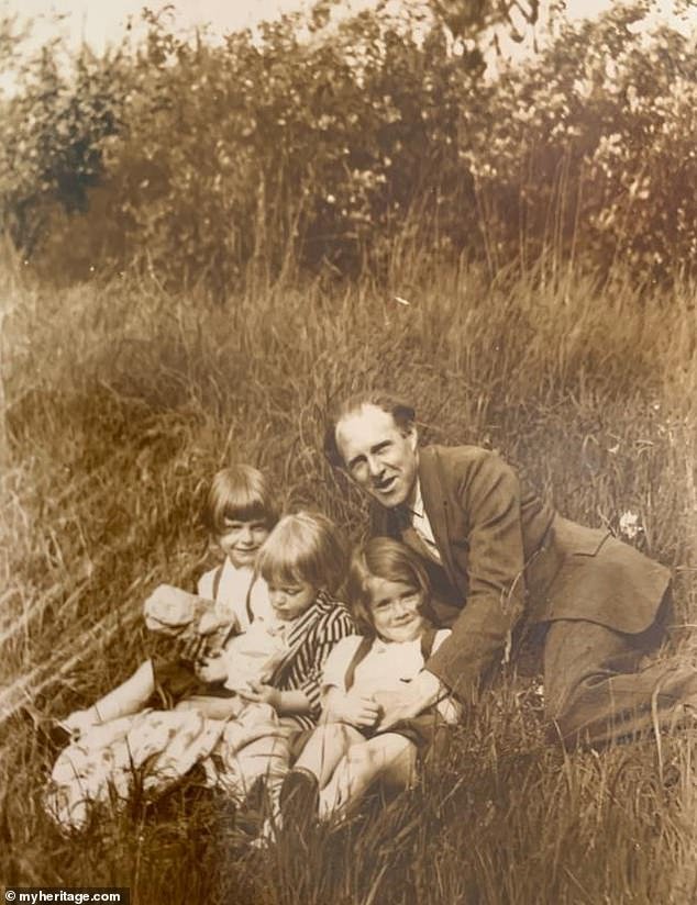Georges Bourlet frolicking in the hay with some of his children