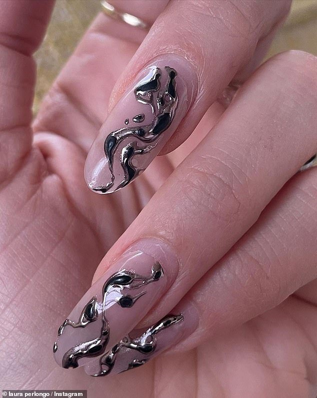 Nails: Her post included several photos and videos of her kids, a mirror selfie showing her stomach, and others, all while sporting the same manicure