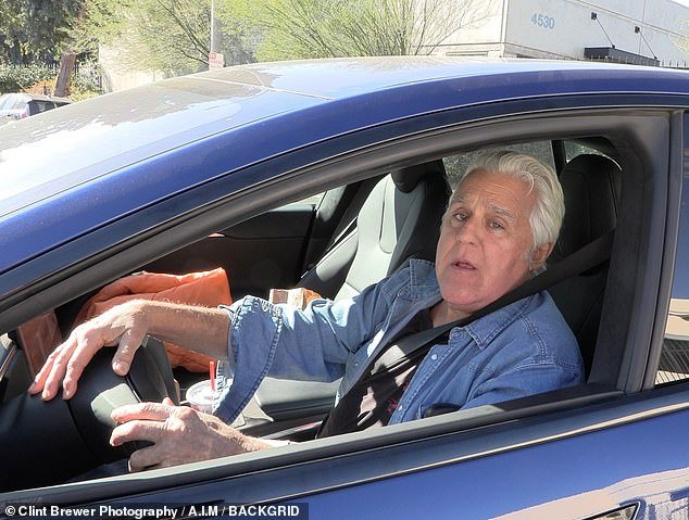 During his outing, the 72-year-old opted for a casual outfit, wearing a button-up denim shirt over a black T-shirt and his long white locks brushed back.  He appeared to have a drink in his cup holder and a bag of fast food on the passenger seat as he drove in his blue Tesla.