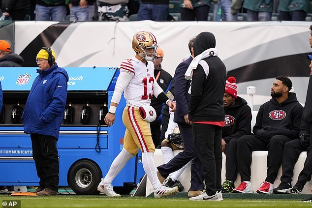 Purdy walks on the sidelines after being knocked out of the NFC title game shortly after his injury.