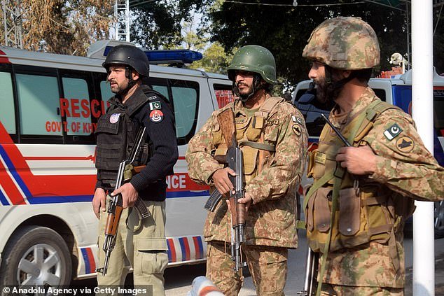 Security forces near the site of the attack in Peshawar, Pakistan. It is believed that the targets of the bomb were police officers