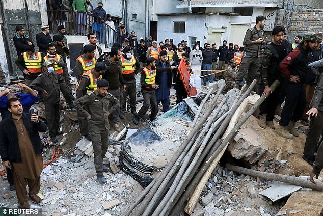 People gathered around the damaged buildings to help look for survivors in the hours after the explosion