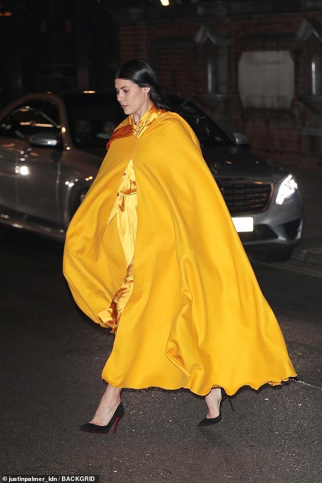 Wow!  The actress looked ultra-glam in a bright yellow satin gown, complete with a matching cape on top.