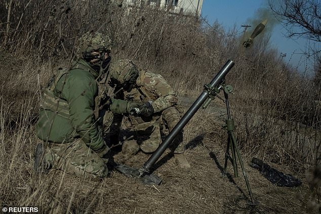 Ukrainian servicemen fire a mortar on a front line, as Russia's attack on Ukraine continues, in Bakhmut, on January 27