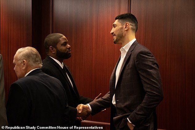Kanter Freedom is shown shaking hands with Florida Republican Rep. Byron Donalds