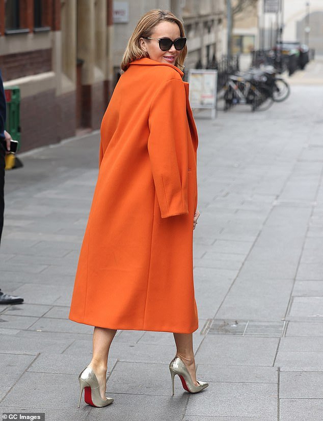 Bold: The female broadcaster turned heads with the daring number, which she paired with a coordinating long wool coat draped over her shoulders