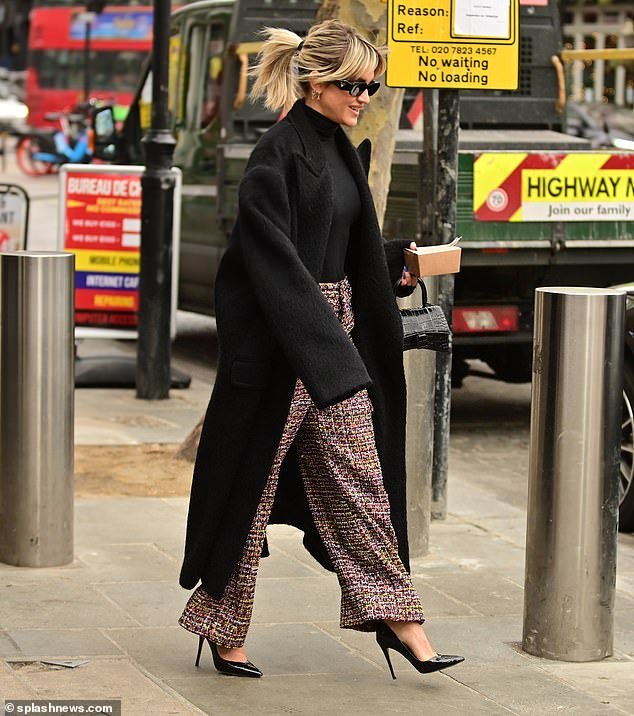 Low-key look: Also seen leaving the radio studio was Ashley Roberts, who looked effortlessly chic in a pair of wide-leg pink and black tweed pants