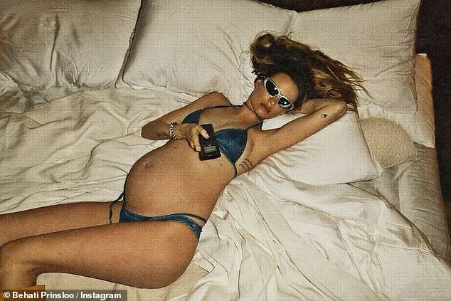 Bumpy lady: The star showed off her tummy in early January while in bed