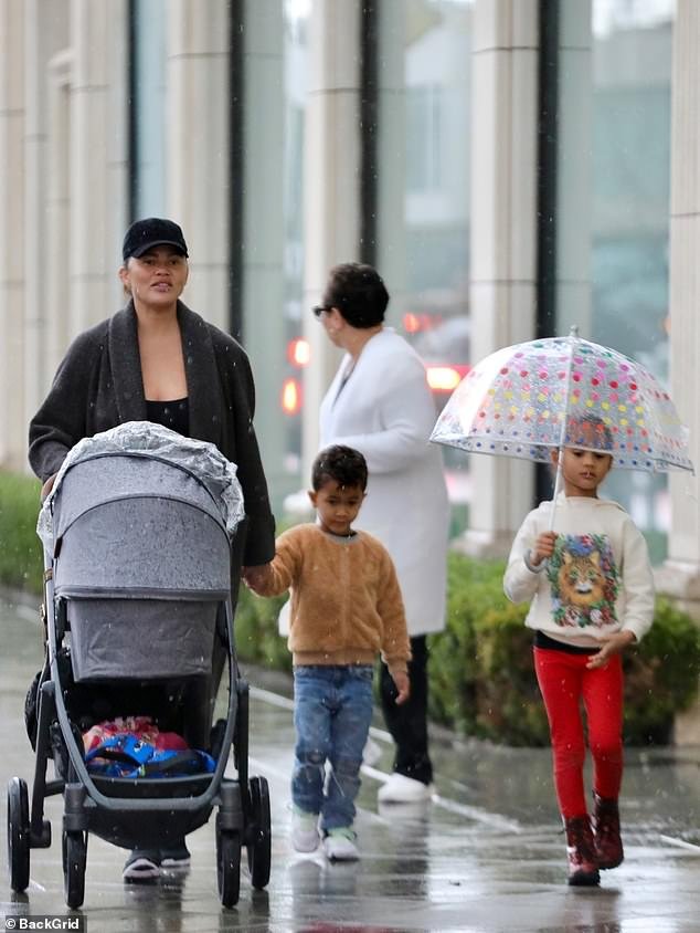 Mom of three: Less than three weeks after giving birth to baby girl Esti Maxine, whom she shares with husband John Legend, the best-selling cookbook author, 37, looked relaxed as she enjoyed a moment nice with his daughter, Luna.  , six, and her son Miles, four