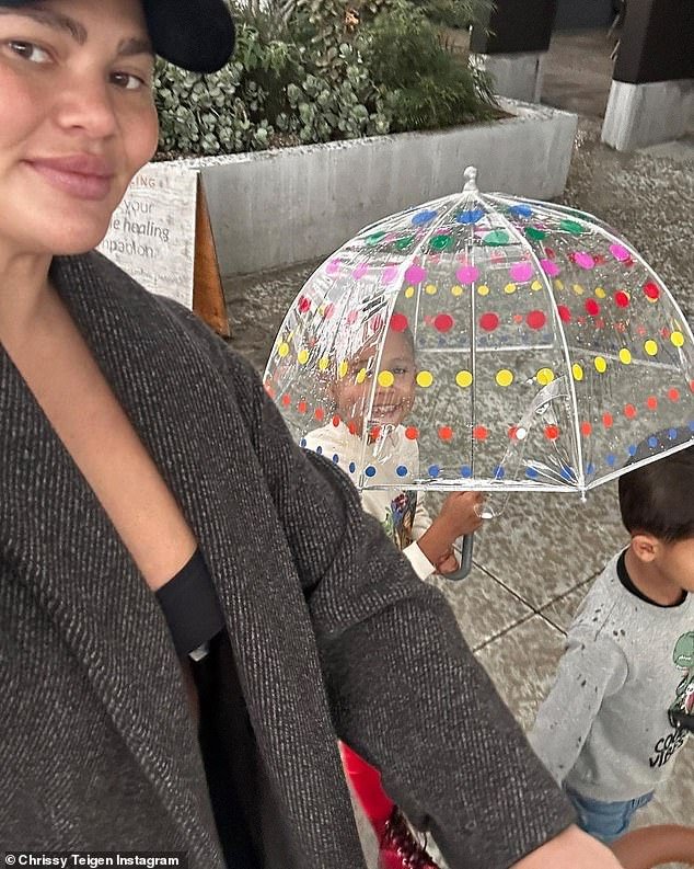 Smiling: Teigen took a sweet selfie with her kids