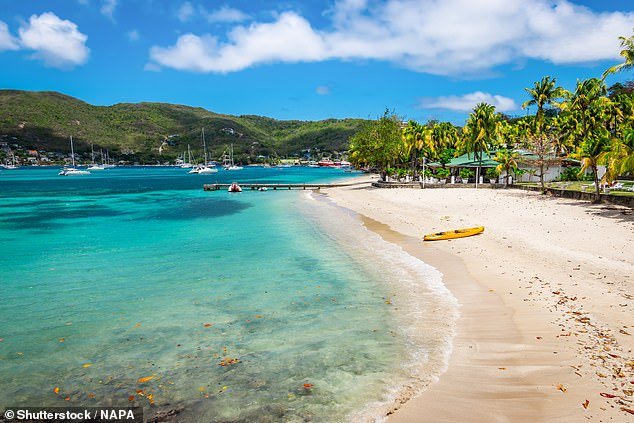 Vibrant: Nick Redman explores the island of Bequia, a treasured spot in the archipelago nation of St. Vincent and the Grenadines.  Above is a beach near the capital, Port Elizabeth.