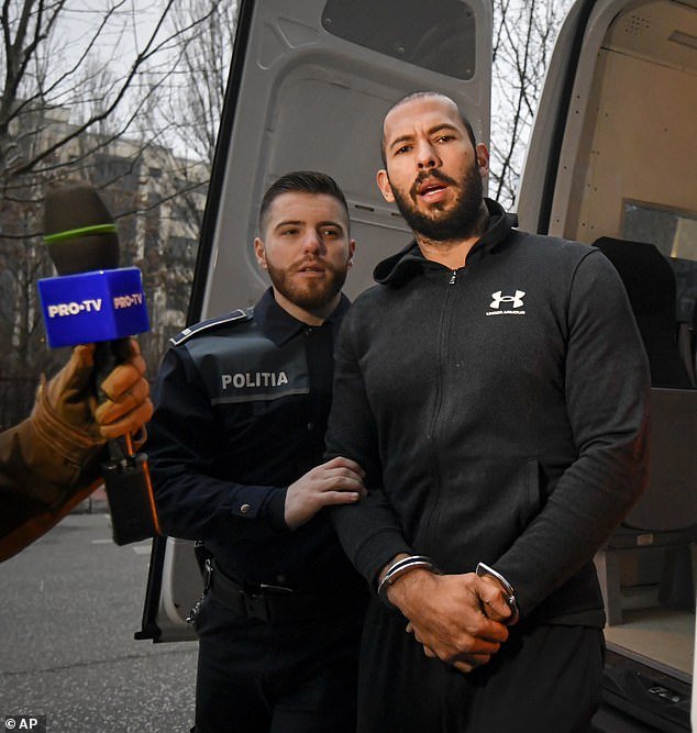 Andrew Tate (pictured in handcuffs) and his brother were moved to DIICOT on Wednesday, where prosecutors examined electronic equipment confiscated during the investigation in their case, in Bucharest.