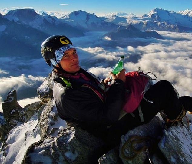 Julian Sands is shown sitting on top of the Weisshorn mountain in the Swiss Alps.