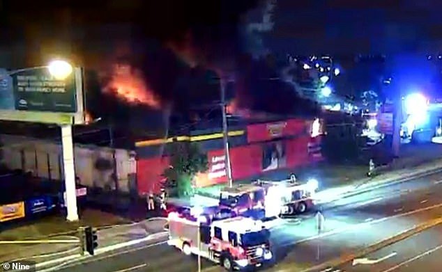 A fire at a Supercheap Auto store in Epping, Melbourne, has been burning for two hours (pictured, firefighters on scene early Wednesday morning)