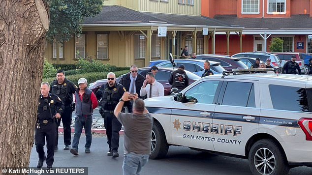 Police officers detain a man, believed by law enforcement to be the suspect in the Half Moon Bay mass shooting, in Half Moon Bay, California, USA, January 23, 2023.