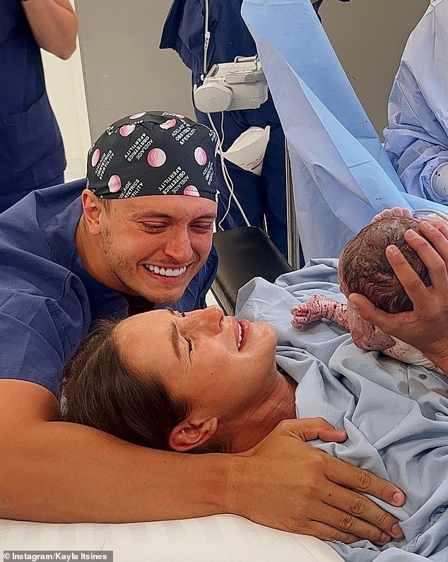 Kayla Itsines welcomed baby Jax into the world last Thursday and hasn't been able to stop smiling ever since.  (She appears in the photo of her with her fiancé Jae Woodroffe after giving birth)