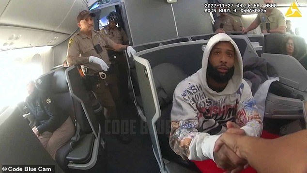 Newly released mugshots show Odell Beckham Jr. belligerently cursing at passengers aboard an American Airlines flight at Miami International Airport and refusing to leave the plane after allegedly telling the flight crew that he was recovering from a night at the club  However, he was respectful of the police, even shaking their hands (pictured)