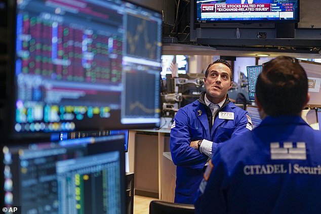 Traders watch screens for information about a trading malfunction on the floor of the New York Stock Exchange on Tuesday.  Federal regulators are investigating a glitch on the exchange that caused wild swings in blue-chip stock prices.