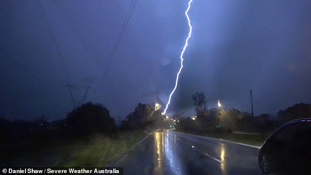 Spectacular dash cam video shows the moment massive lightning struck near cars on a busy street near Narellan in western Sydney.