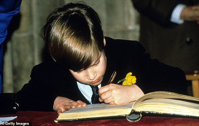 An eight-year-old Prince William signs the visitor's book at Llandaff Cathedral on his first official engagement, on St David's Day, 1991 in Cardiff, Wales