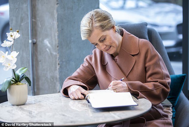 Sophie signs a book as she opens a new studio for the Central School of Ballet, London in 2020