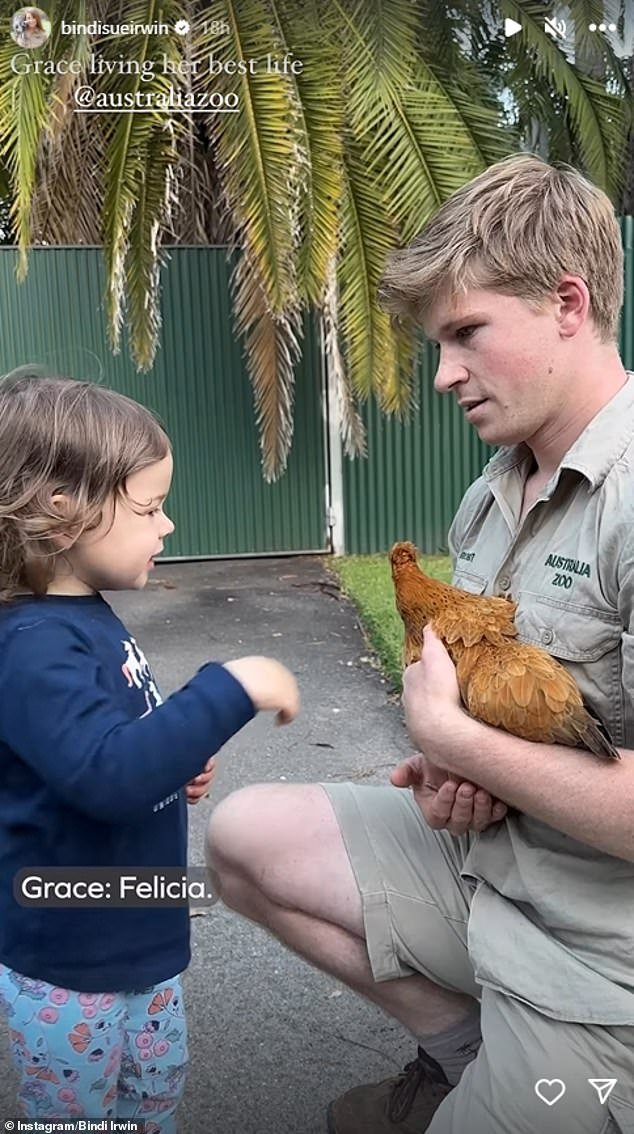 Grace is seen petting a chicken being held by her uncle Robert before marveling at some lemurs and feeding a turtle a flower