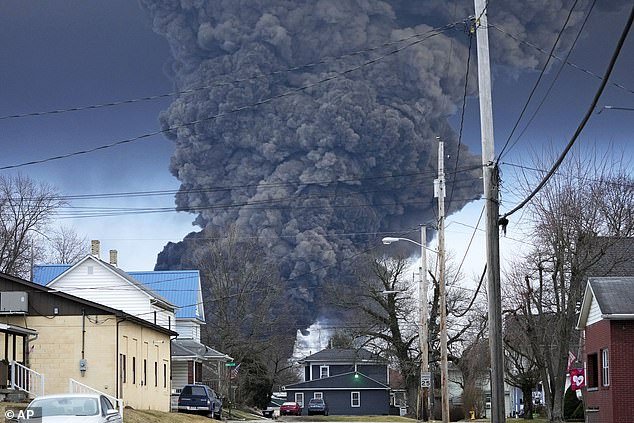A black plume rises over East Palestine, Ohio, as a result of a controlled detonation of part of the derailed Norfolk Southern trains days after the derailment
