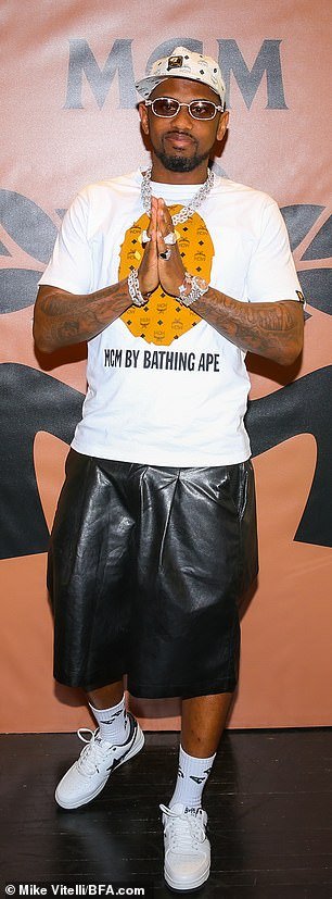 Trendsetter: Rapper Fabulous wore a Bathing Ape t-shirt along with black pants, a hat and a layer of diamond necklaces